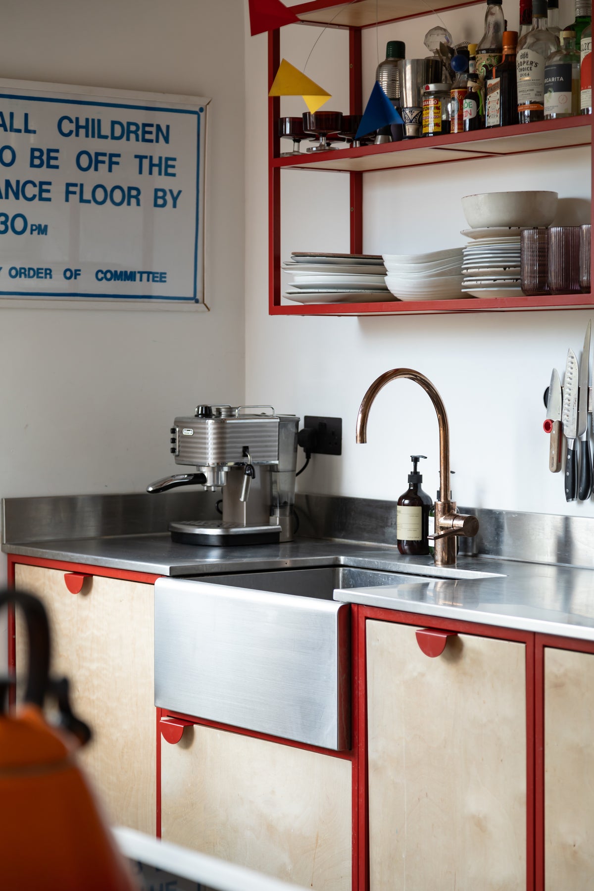 stainless steel worktop and Belfast sink, open steel shelves 
