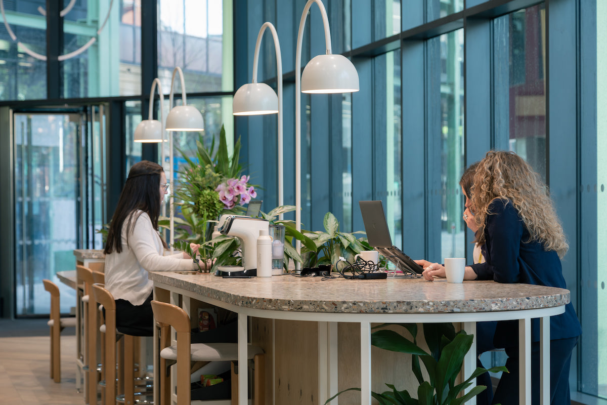 co working reception desk in large office  glass atrium 