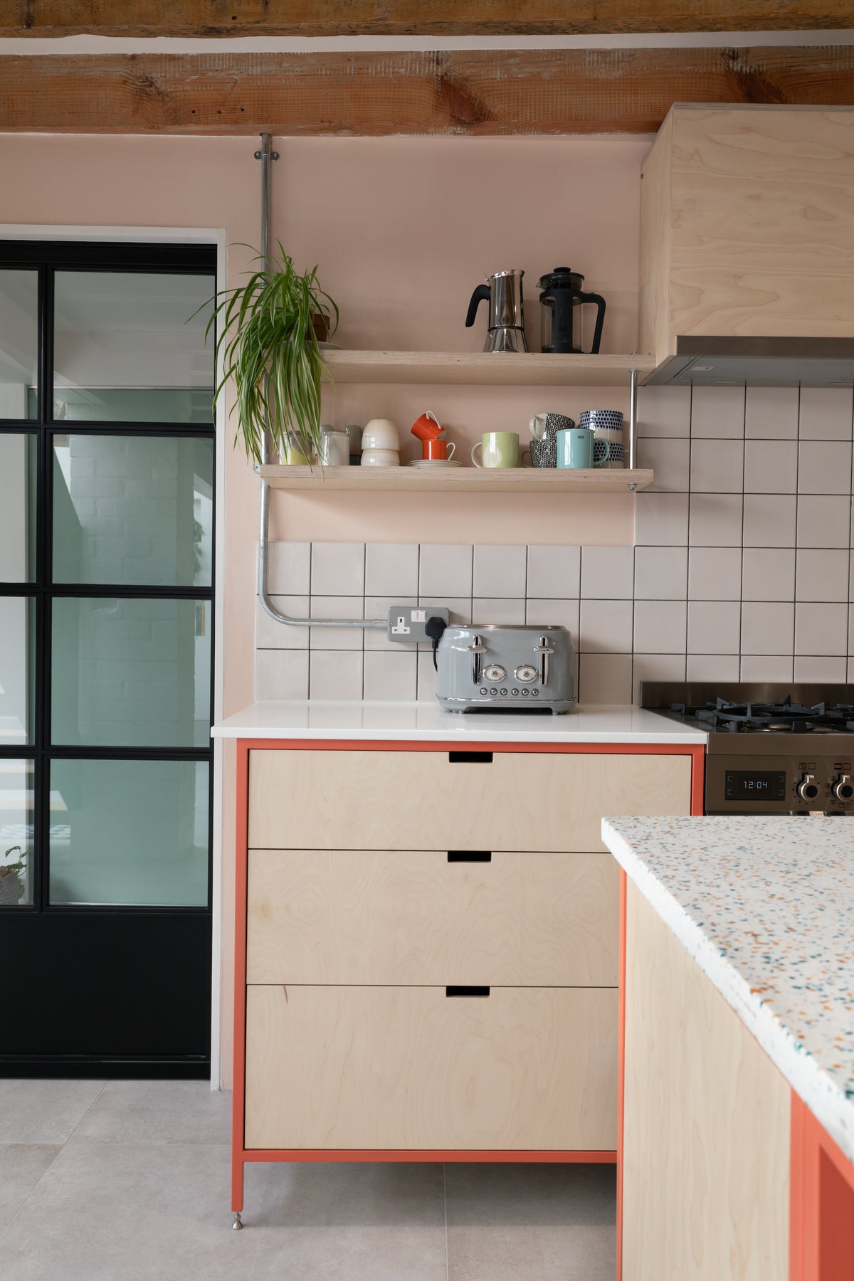 free standing kitchen units in a metal frame and birch plywood fronts 